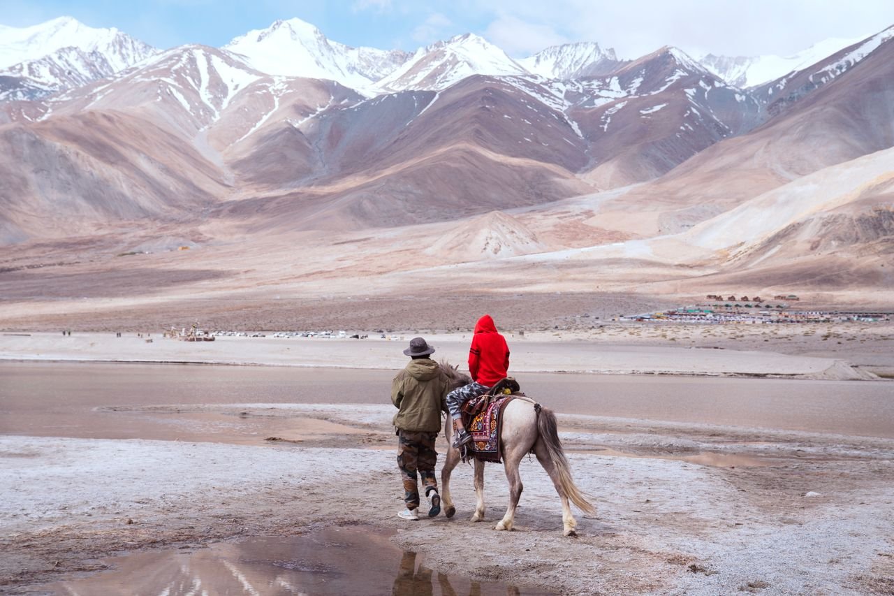 services-01 A serene horseback ride along the shores of Pangong Lake, surrounded by the majestic Himalayas.